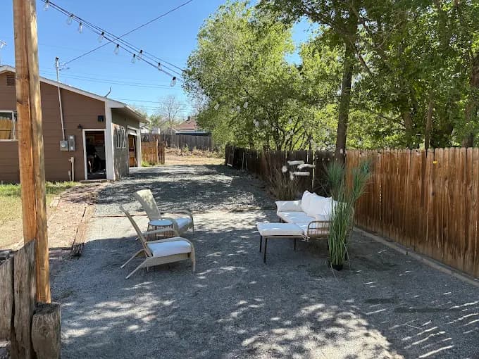 Backyard gravel patio with lounge seating and string lights in Colorado Springs
